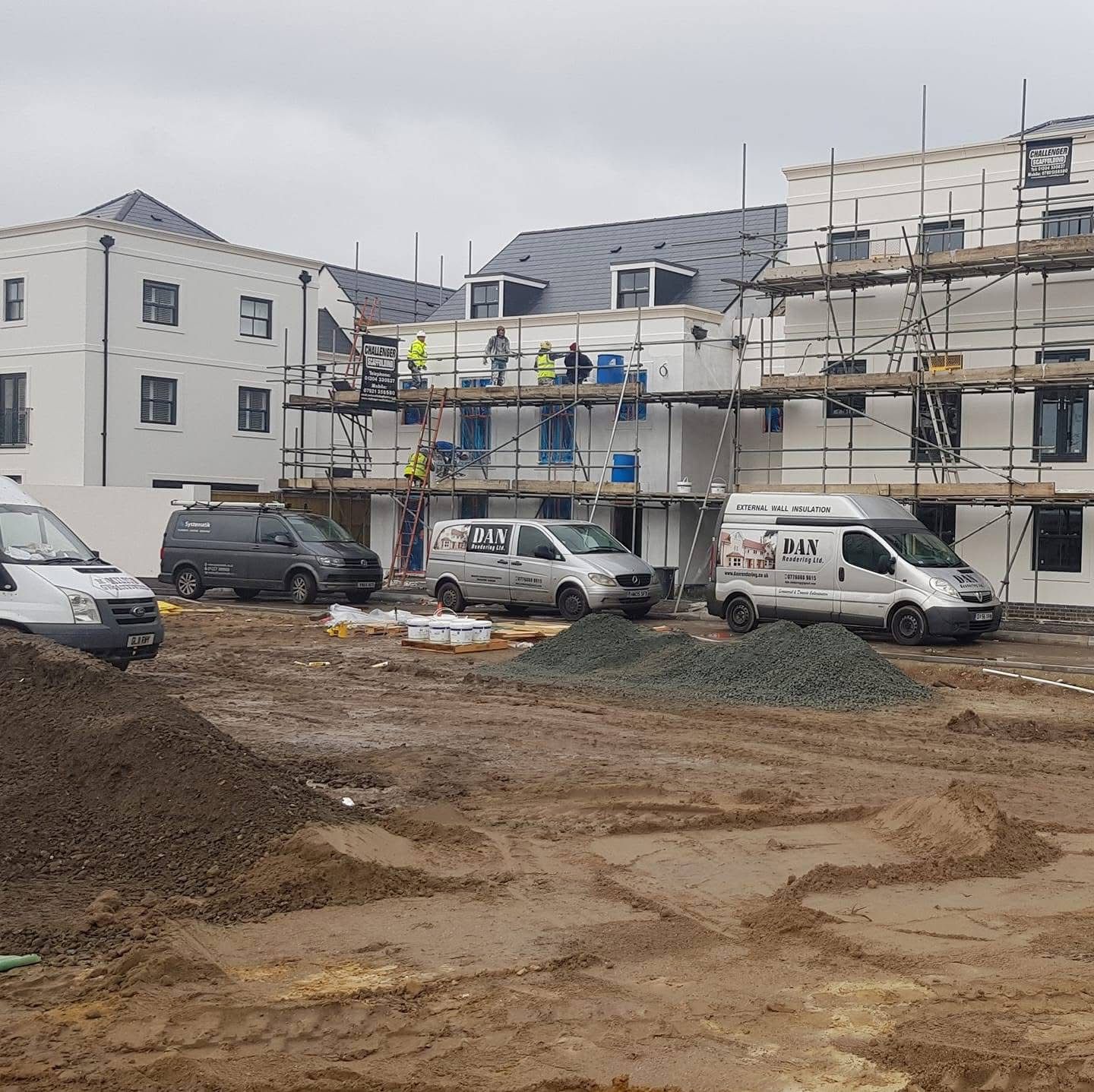 Dan Rendering Ltd vans and scaffolding on a residential development site